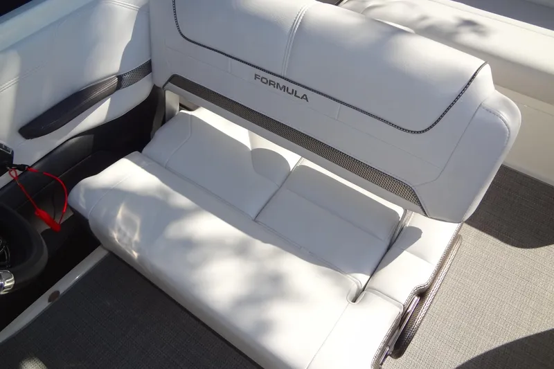 Slide: The Image of 2020 Formula 240 Bowrider boat with sleek white seating and integrated cup holders. - 23