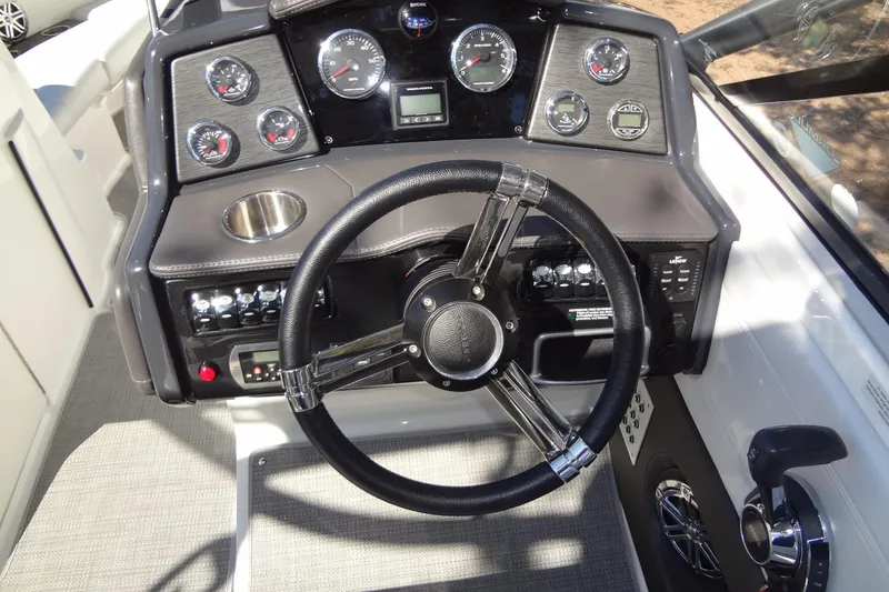 Slide: The Image of 2020 Formula 240 Bowrider interior seating with white upholstery and cup holder. - 25