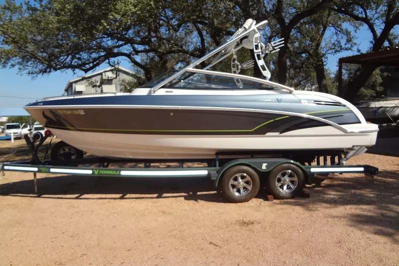 Slide: The Image of 2020 Formula 240 Bowrider boat on trailer, parked in driveway, sunny day. - 3