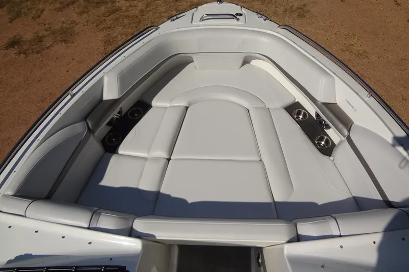 Slide: The Image of 2020 Formula 240 Bowrider boat interior with white seating and cup holders. - 43