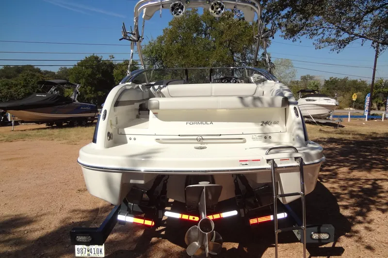 Slide: The Image of 2020 Formula 240 Bowrider boat on trailer, parked in driveway, covered and ready for transport. - 5