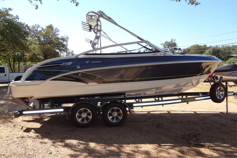Slide: The Image of 2020 Formula 240 Bowrider on trailer by a lake, ready for adventure. - 7