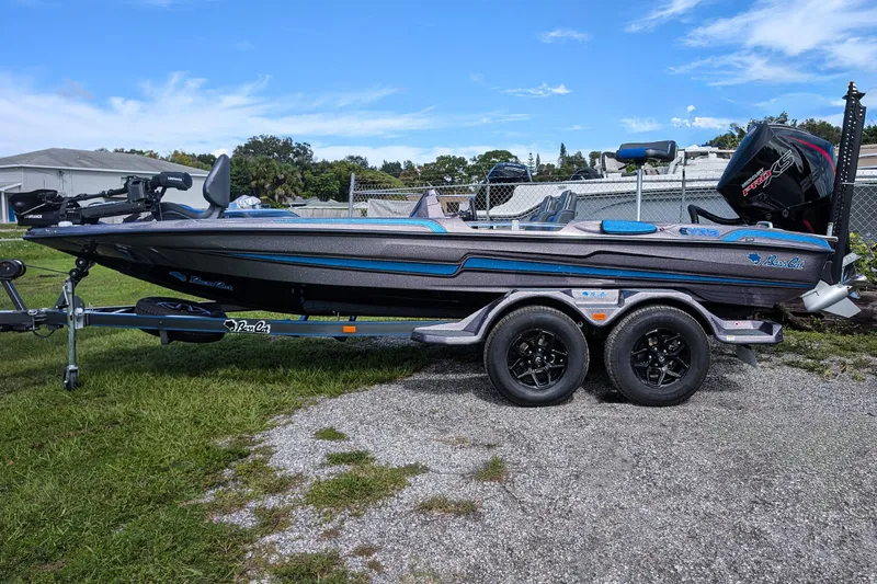 Slide: The Image of 2026 Bass Cat Eyra SP boat on trailer, parked outdoors on grass. - 4