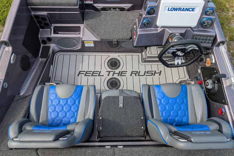 Slide: The Image of 2026 Bass Cat Eyra SP boat interior with blue seats and "Feel the Rush" flooring. - 6