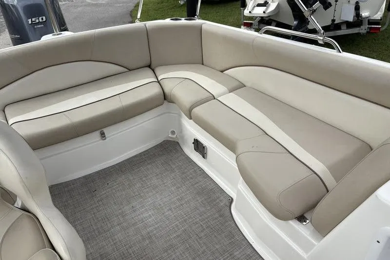 Slide: The Image of 2022 NauticStar 203 SC boat on trailer, parked outdoors with a canopy. - 11