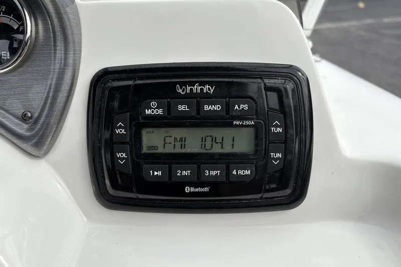 Slide: The Image of 2022 NauticStar 203 SC boat interior with beige seating and steering console. - 13