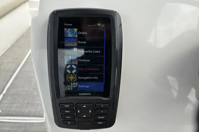 Slide: The Image of 2022 NauticStar 203 SC boat interior with beige seating and gray flooring. - 15