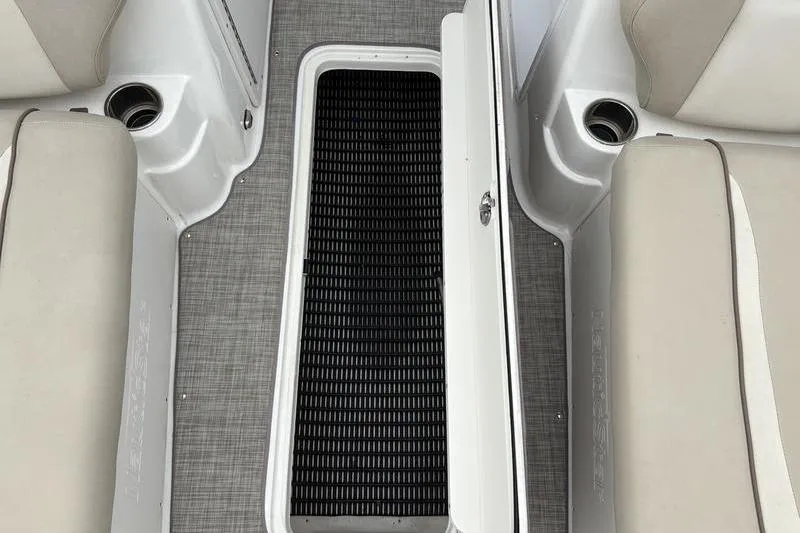 Slide: The Image of 2022 NauticStar 203 SC boat interior with beige seating and storage compartment. - 21