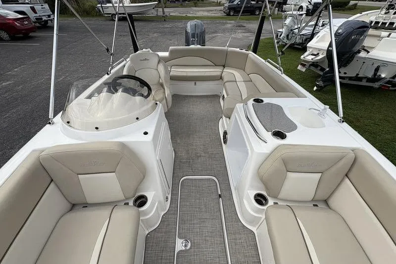 Slide: The Image of 2022 NauticStar 203 SC boat interior with beige seating and steering wheel. - 23