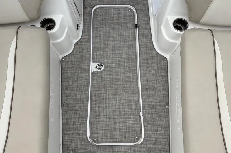 Slide: The Image of 2022 NauticStar 203 SC boat interior with gray flooring and beige seating. - 24