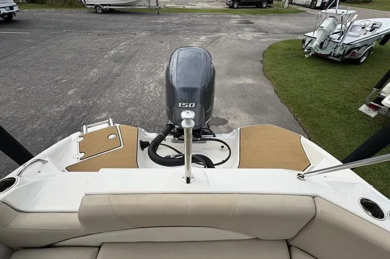 Slide: The Image of 2022 NauticStar 203 SC boat with 150 HP engine, parked on a trailer. - 6