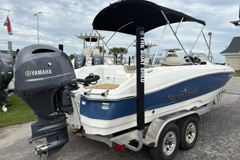 Slide: The Image of 2022 NauticStar 203 SC boat with Yamaha engine on trailer, parked outdoors. - 7