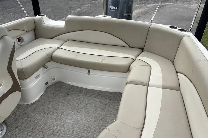 Slide: The Image of 2022 NauticStar 203 SC boat on trailer with canopy, parked outdoors. - 9