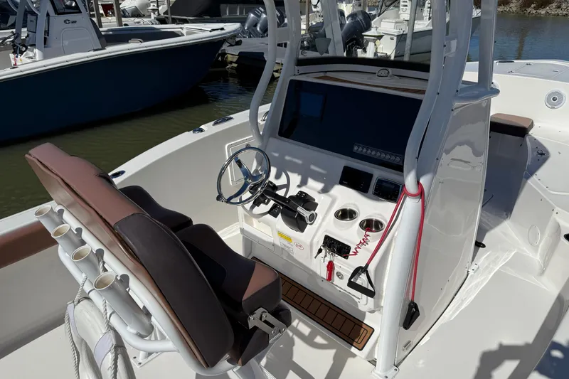 Slide: The Image of 2017 Tidewater 252 CC Adventure boat console with steering wheel and controls. - 1