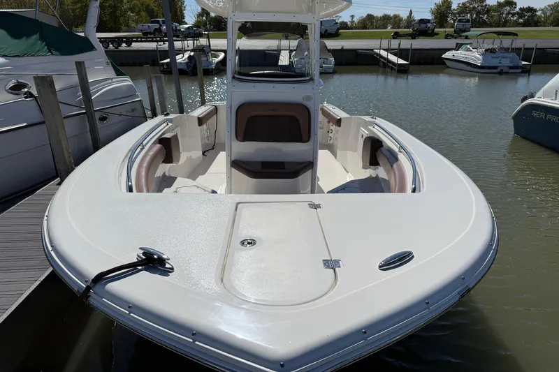 Slide: The Image of 2017 Tidewater 252 CC Adventure boat docked at marina, showcasing spacious deck. - 4