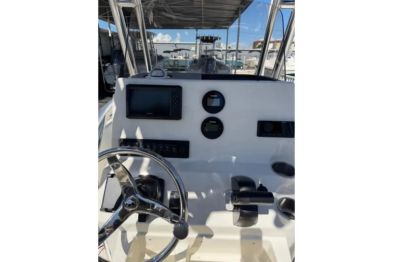 Slide: The Image of 2026 Key West 189 FS boat dashboard with steering wheel and navigation controls. - 18