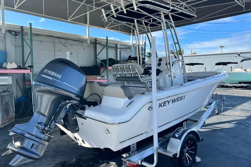 Slide: The Image of 2026 Key West 189 FS boat with Yamaha engine on trailer, parked under canopy. - 4