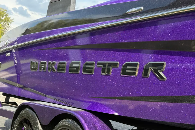 Slide: The Image of 2015 Malibu Wakesetter 24 MXZ boat with sparkling purple finish and bold lettering. - 10