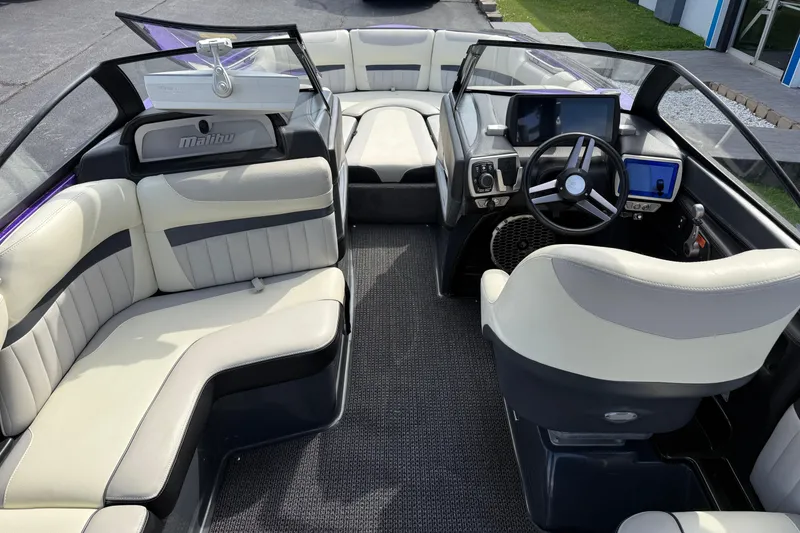 Slide: The Image of 2015 Malibu Wakesetter 24 MXZ interior with modern dashboard and spacious seating. - 13