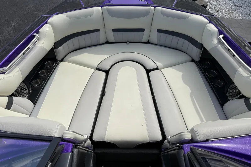 Slide: The Image of 2015 Malibu Wakesetter 24 MXZ boat interior with white and gray seating. - 14