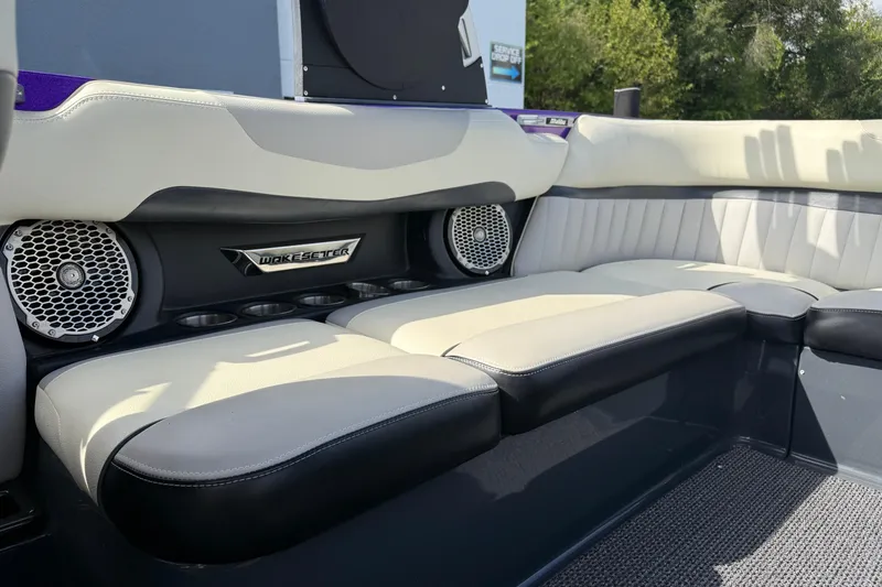 Slide: The Image of 2015 Malibu Wakesetter 24 MXZ interior with cushioned seating and built-in speakers. - 20