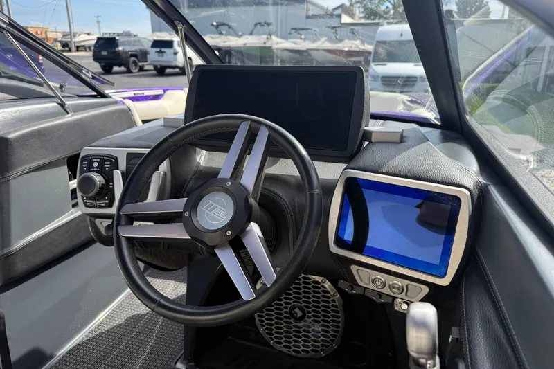 Slide: The Image of 2015 Malibu Wakesetter 24 MXZ dashboard with steering wheel and digital displays. - 22