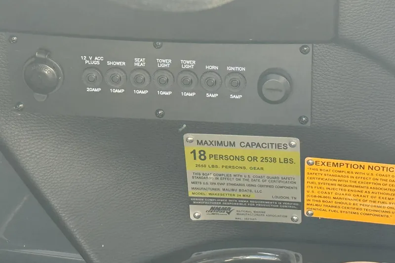 Slide: The Image of Control panel of a 2015 Malibu Wakesetter 24 MXZ boat with capacity labels. - 23