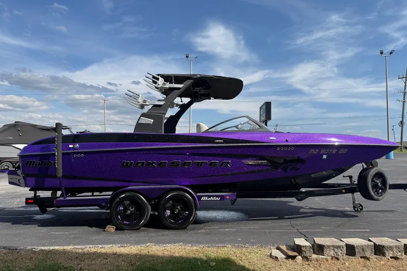 Slide: The Image of 2015 Malibu Wakesetter 24 MXZ boat in vibrant purple on a trailer. - 4