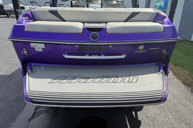Slide: The Image of 2015 Malibu Wakesetter 24 MXZ boat, purple exterior, rear view with swim platform. - 9