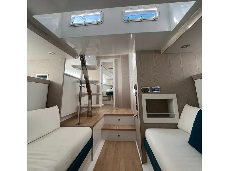 Slide: The Image of 2024 Fiart 39 Seawalker interior with modern seating, wooden flooring, and natural light. - 18