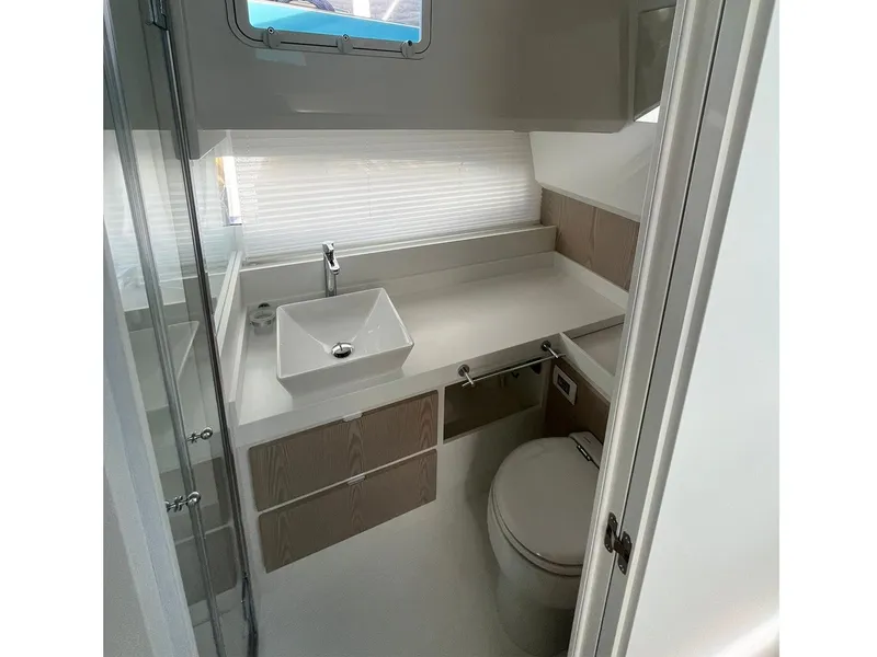 Slide: The Image of 2024 Fiart 39 Seawalker bathroom with modern sink, toilet, and storage cabinets. - 24