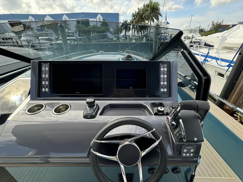 Slide: The Image of 2024 Fiart 39 Seawalker helm with modern controls and dual displays at marina. - 9