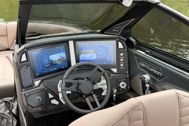 Slide: The Image of 2026 Centurion Ri245 boat dashboard with dual touchscreens and modern steering wheel. - 12