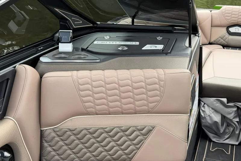 Slide: The Image of 2026 Centurion Ri245 boat interior with beige quilted seating and cup holders. - 13