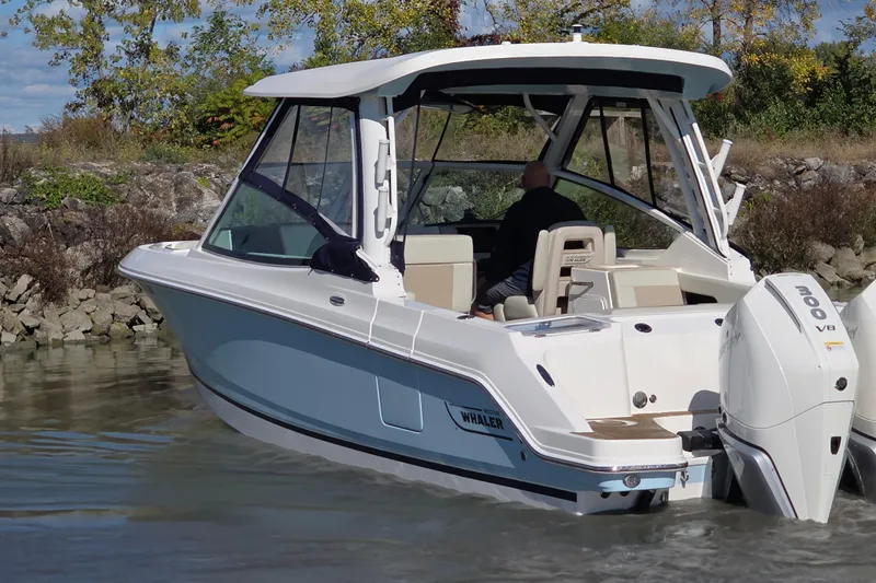 Slide: The Image of 2024 Boston Whaler 280 Vantage boat cruising on a calm waterway. - 7