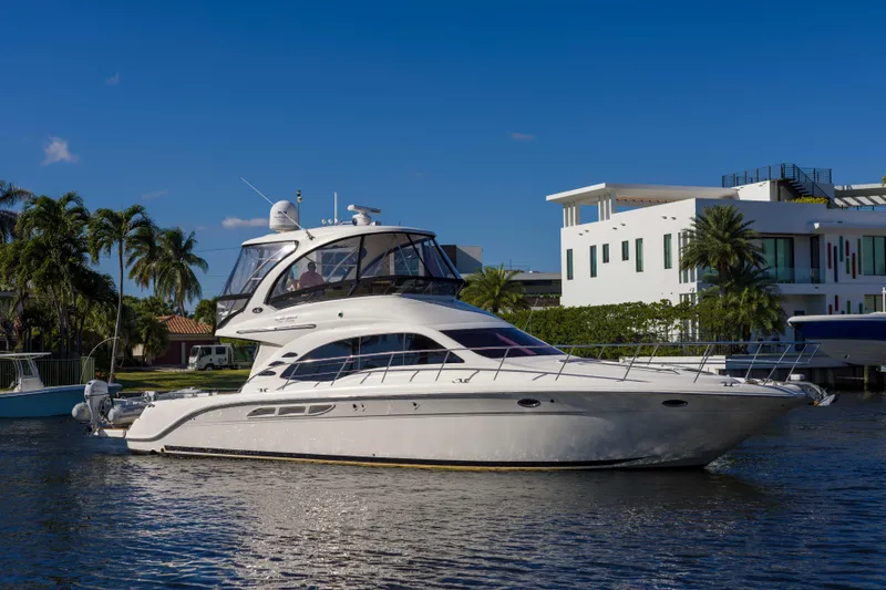 The Image of 2013 Sea Ray 520 Sedan Bridge yacht on a sunny waterfront. - 0
