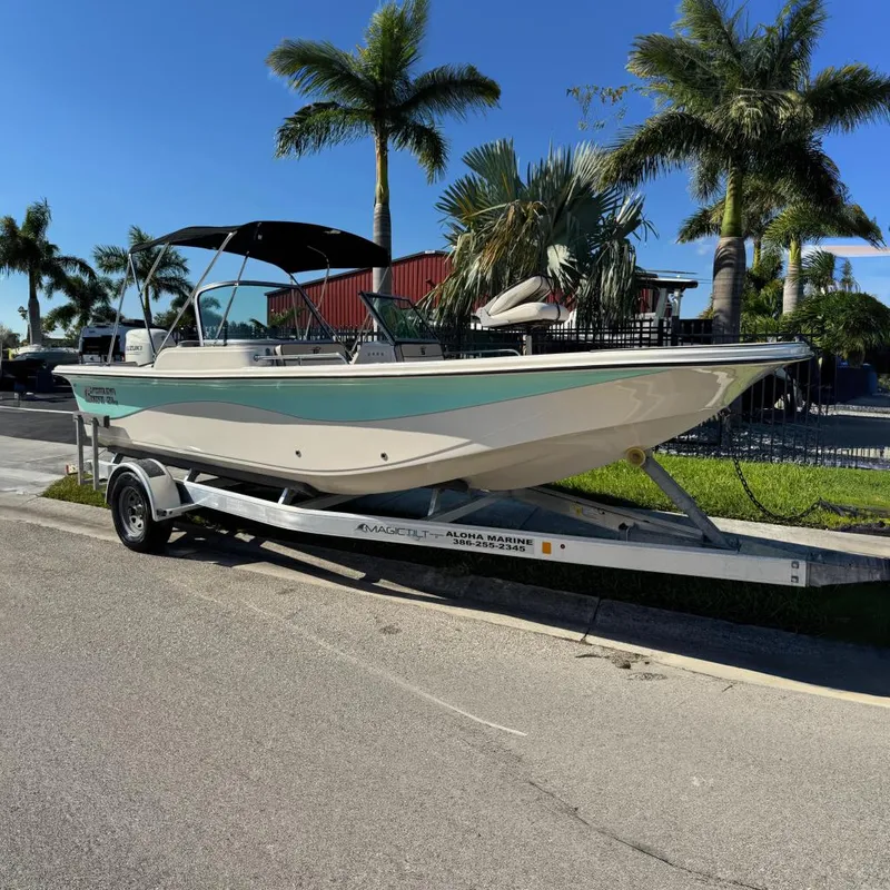 The Image of 2020 Carolina Skiff 21 LS DC boat on trailer, parked near palm trees. - 0