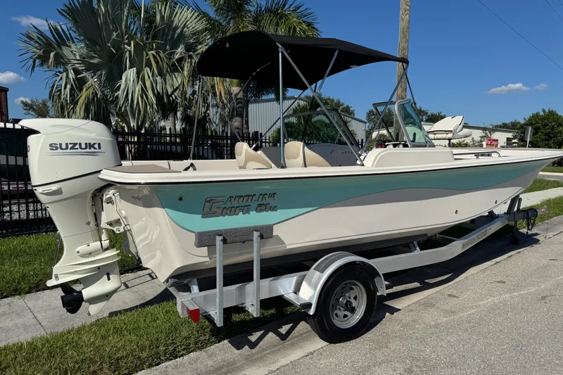 Slide: The Image of 2020 Carolina Skiff 21 LS DC boat with Suzuki outboard motor on trailer. - 11