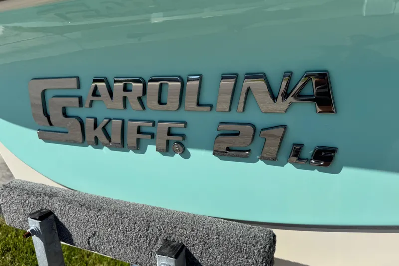Slide: The Image of 2020 Carolina Skiff 21 LS DC boat logo on light blue hull. - 12