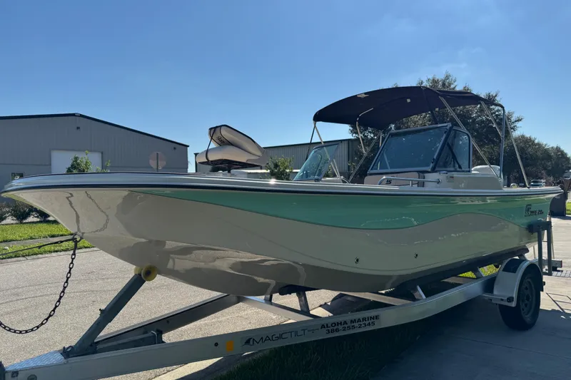 Slide: The Image of 2020 Carolina Skiff 21 LS DC boat on trailer, parked outdoors under clear sky. - 19