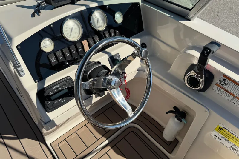 Slide: The Image of 2020 Carolina Skiff 21 LS DC boat dashboard with steering wheel and controls. - 24