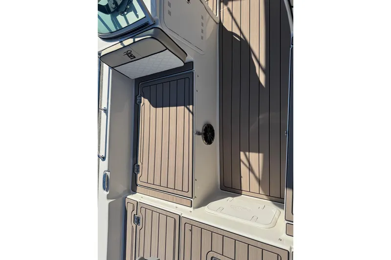 Slide: The Image of 2020 Carolina Skiff 21 LS DC boat interior with wood paneling and storage compartments. - 27