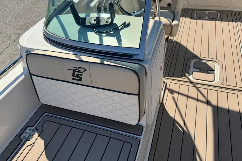 Slide: The Image of 2020 Carolina Skiff 21 LS DC boat interior with cushioned seating and teak-style flooring. - 36