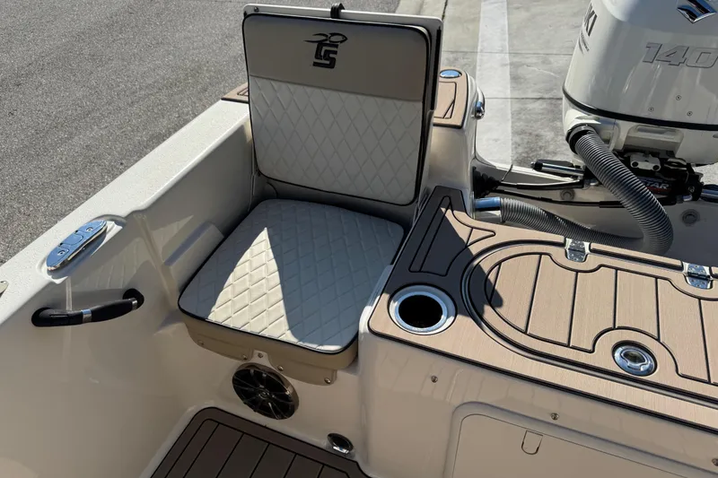 Slide: The Image of 2020 Carolina Skiff 21 LS DC boat interior with cushioned seating and Suzuki outboard motor. - 41