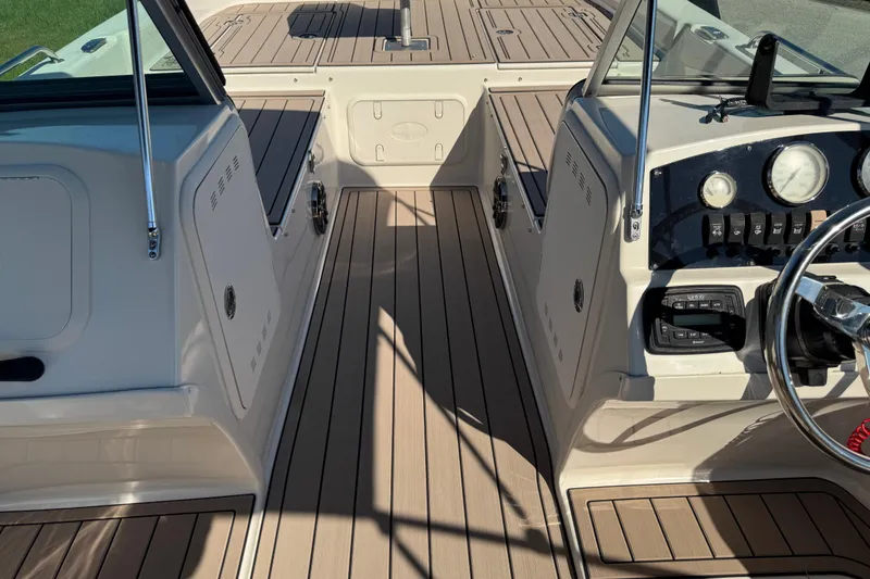 Slide: The Image of 2020 Carolina Skiff 21 LS DC boat interior with sleek dashboard and wood-style flooring. - 47