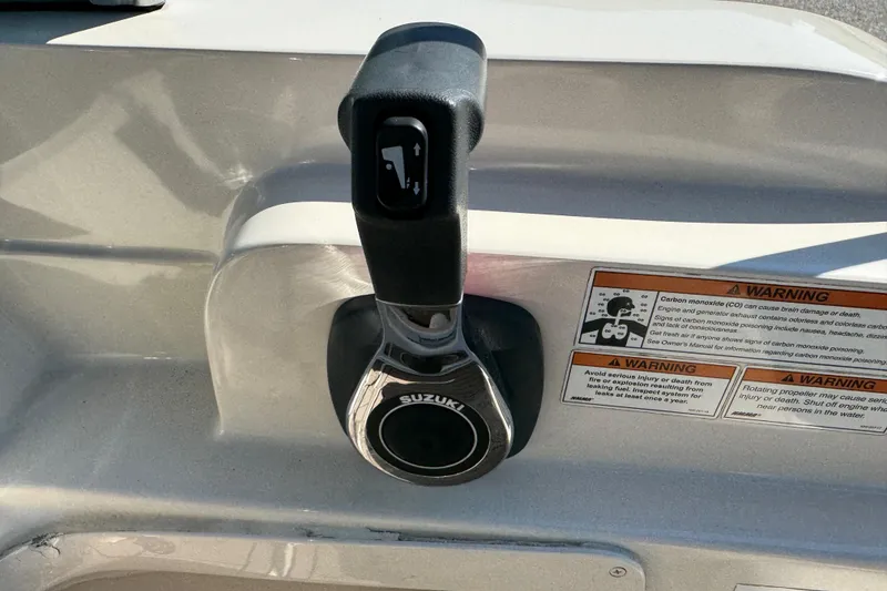 Slide: The Image of Throttle control of a 2020 Carolina Skiff 21 LS DC boat with warning labels. - 48