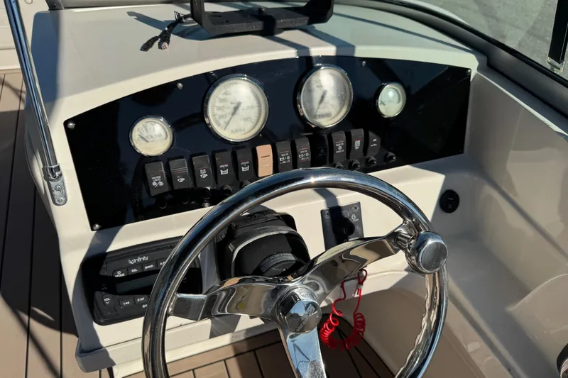 Slide: The Image of 2020 Carolina Skiff 21 LS DC boat dashboard with steering wheel and gauges. - 49