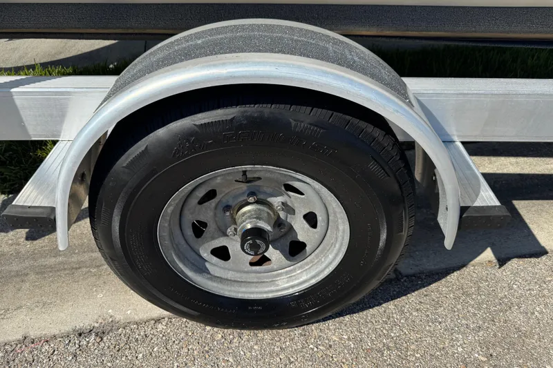 Slide: The Image of Trailer wheel of a 2020 Carolina Skiff 21 LS DC boat on pavement. - 5