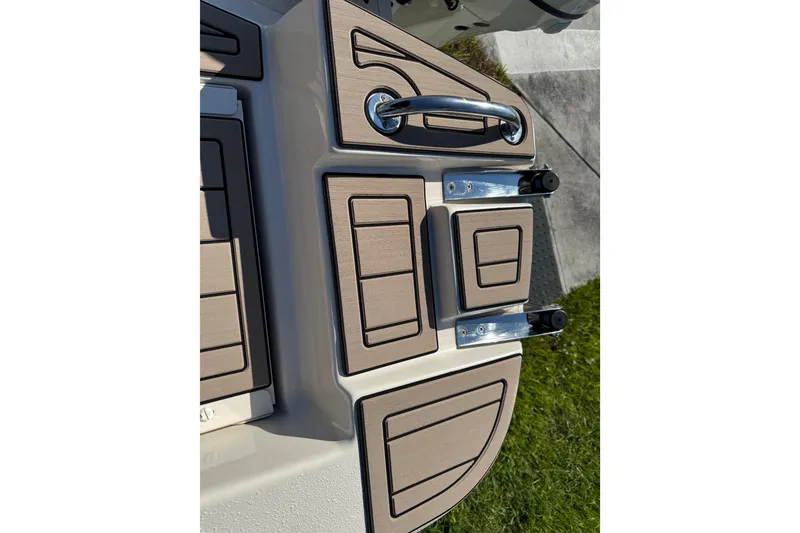 Slide: The Image of 2020 Carolina Skiff 21 LS DC boat deck with wood accents and metal fixtures. - 55