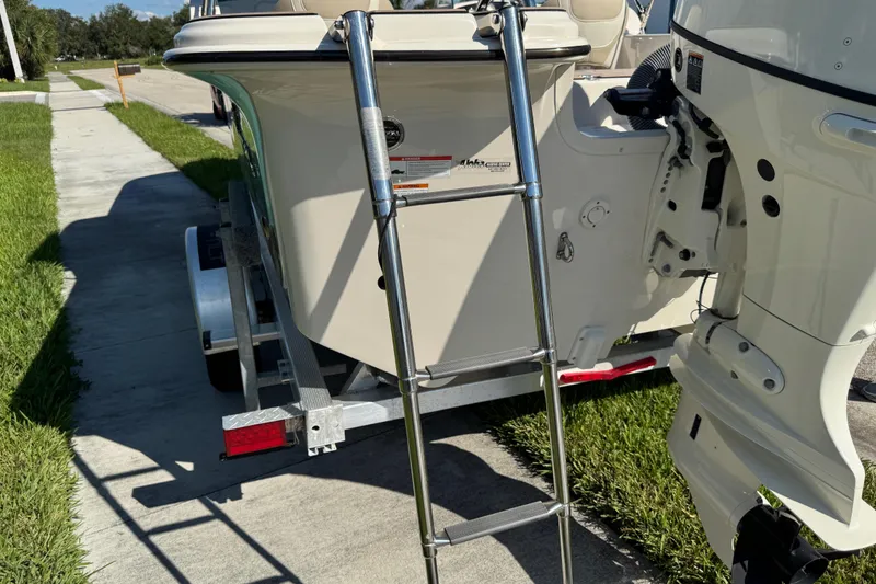 Slide: The Image of 2020 Carolina Skiff 21 LS DC boat with ladder and outboard motor on trailer. - 56